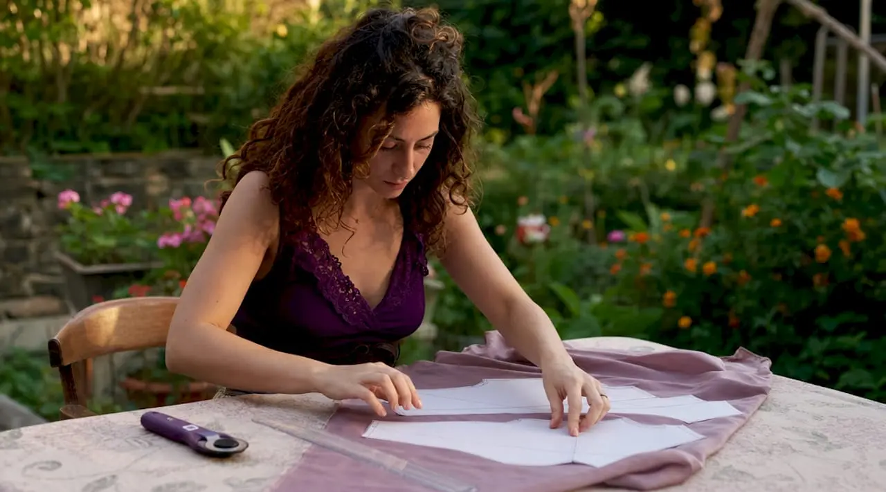 Woman working with digital paper patterns on fabric