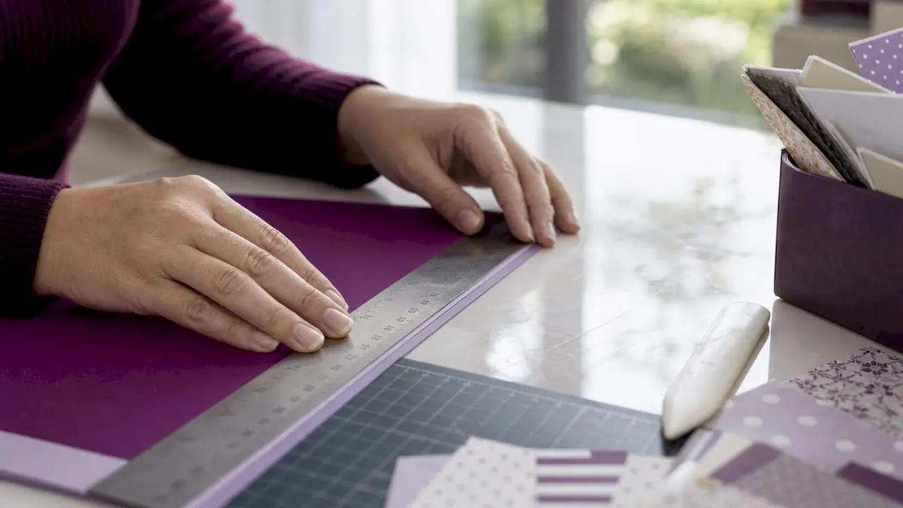 Hands measuring card layout border precisely