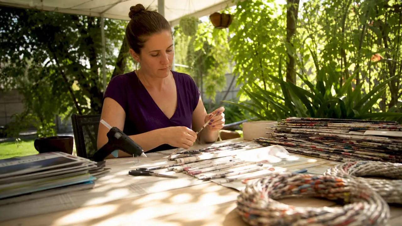 Woman making upcycled paper crafts at home