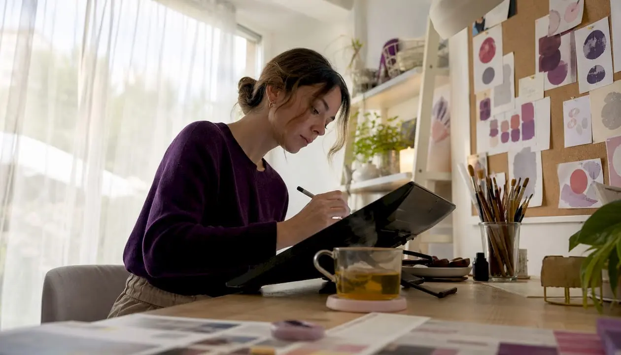 Woman creating digital craft designs at desk