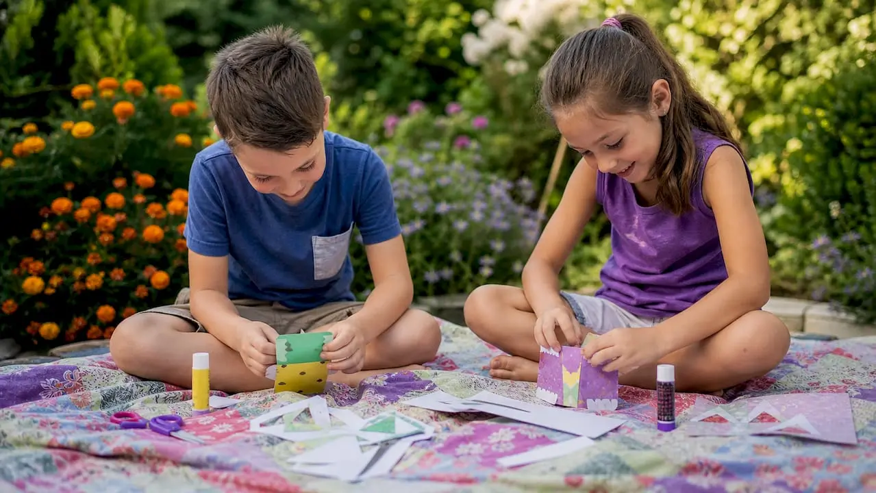 Children creating papercraft kits