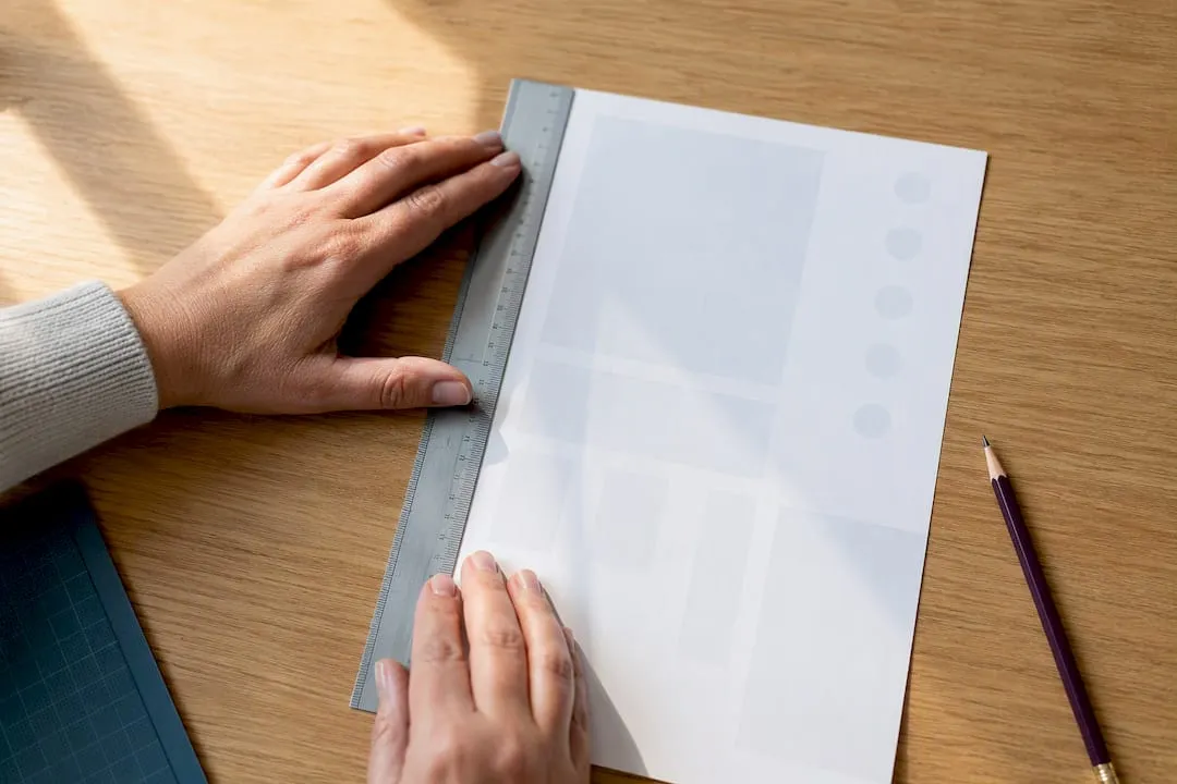 Hands measuring a printed test sheet
